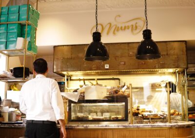 Warm bakery interior with pastry counter and staff, perfect for food and business themes.