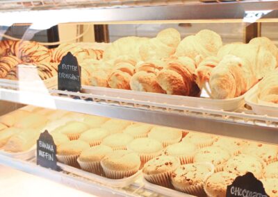 A tempting display of croissants and muffins fresh from the bakery, ready to enjoy.